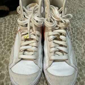 Nike White High-Top Sneakers with orange swoosh